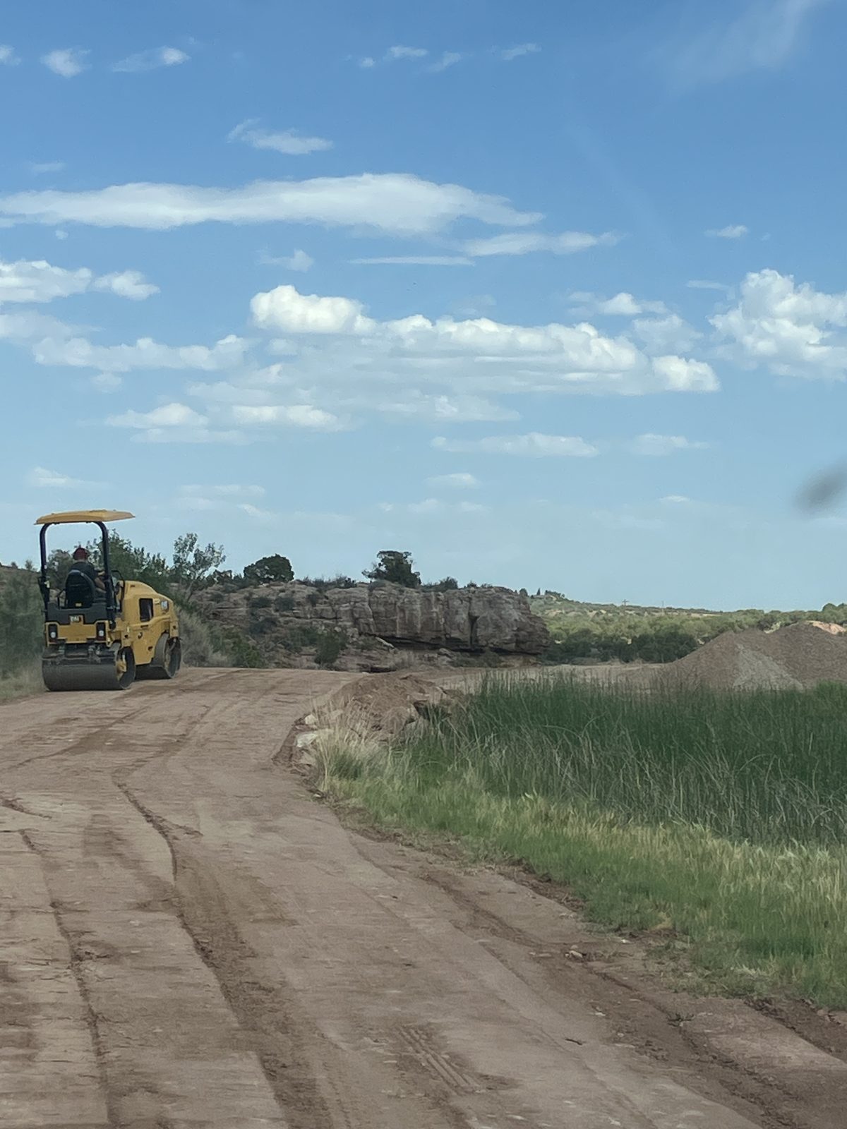 Dirt road grading with mountain views