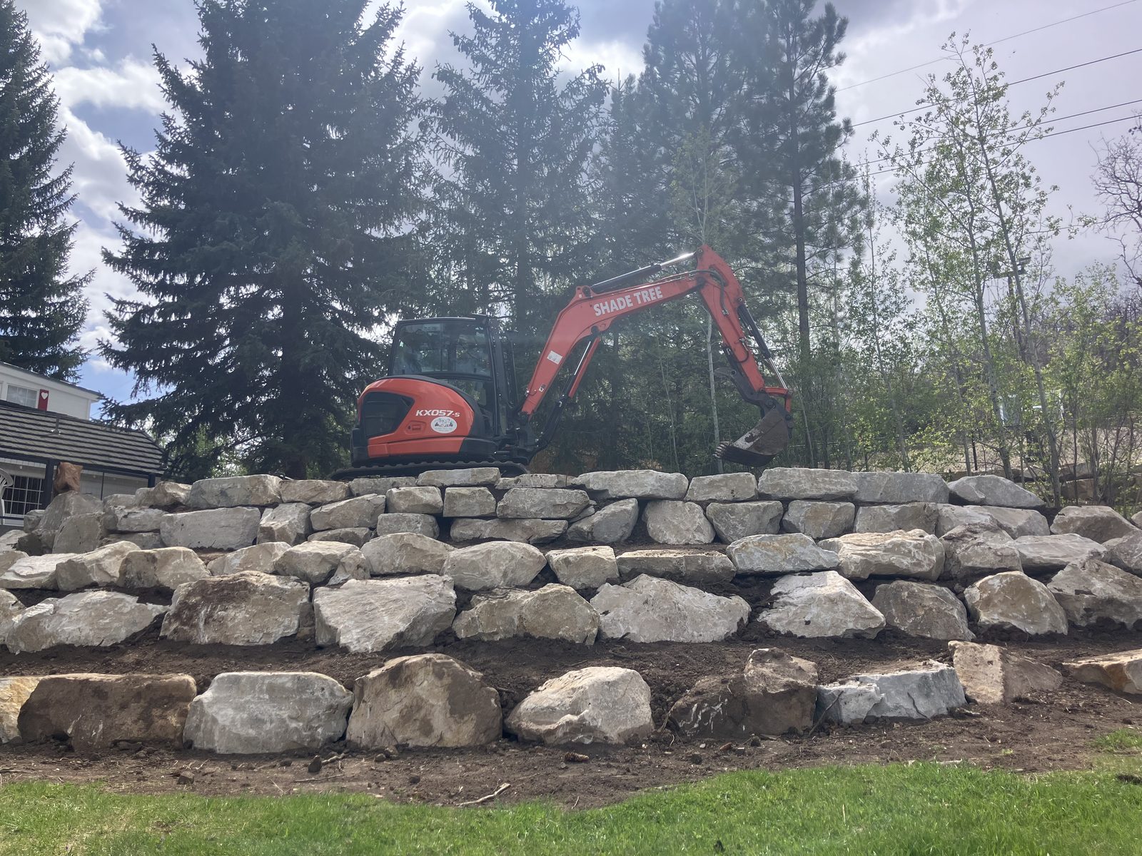 Excavator working near new home foundation
