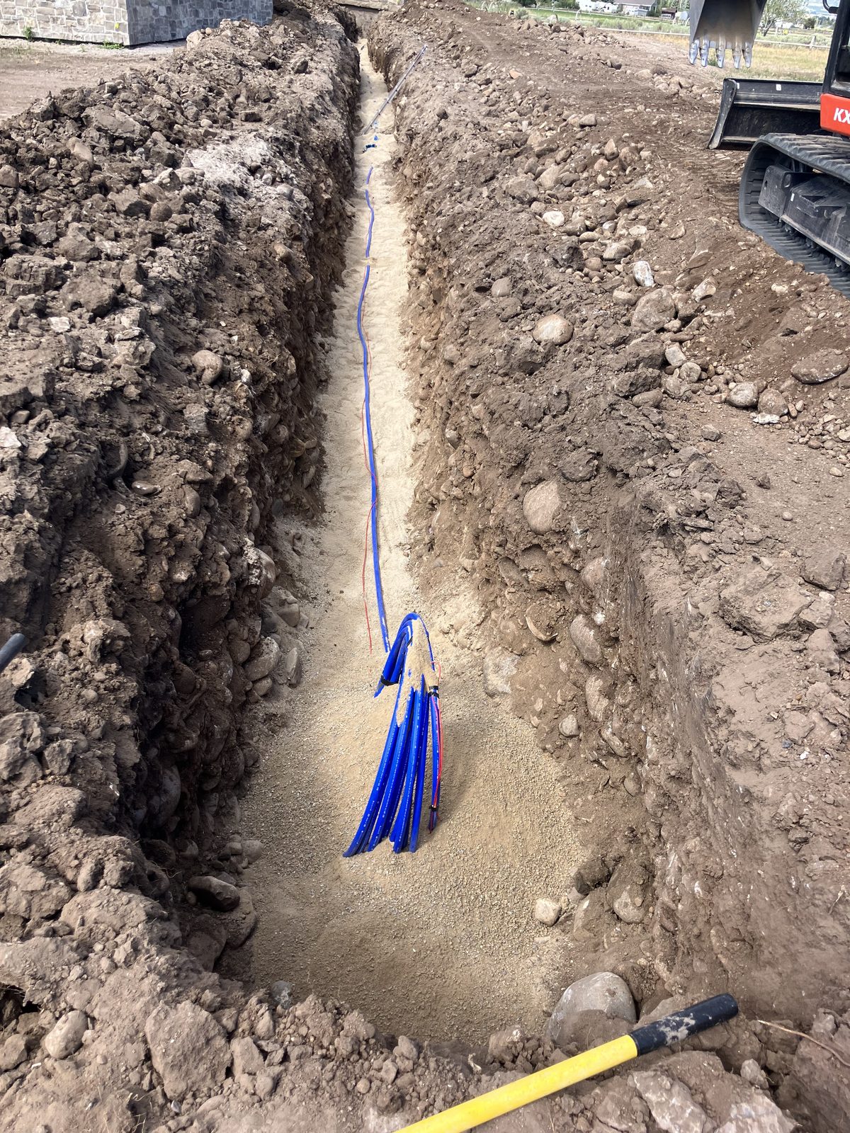 Trench excavation with utility conduit